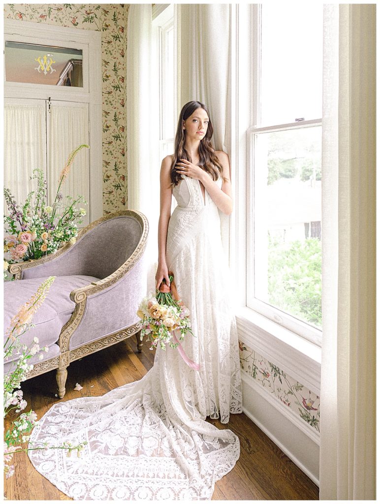 Bride standing next to a window