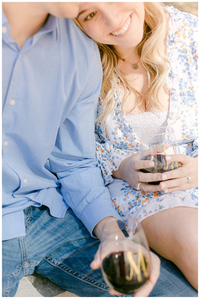 couple drinking wine together during engagement session