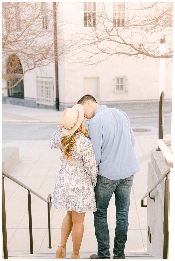 photo of couple kissing from behind on steps