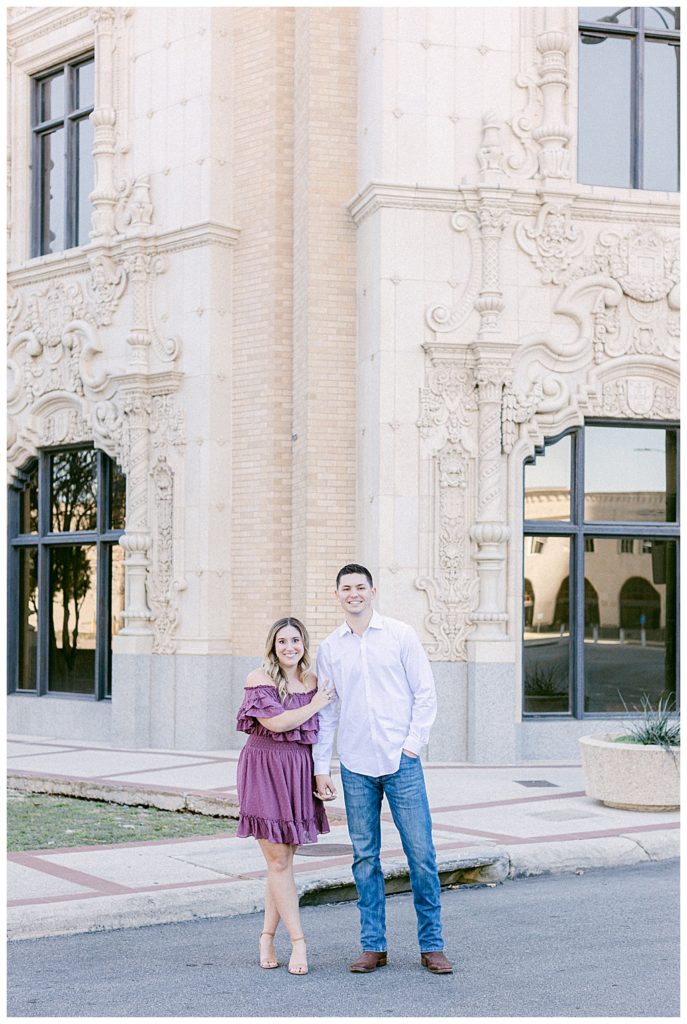 couple standing in front of buildings during downtown san antonio engagement session
