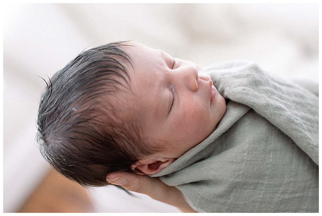 newborn baby with long dark hair