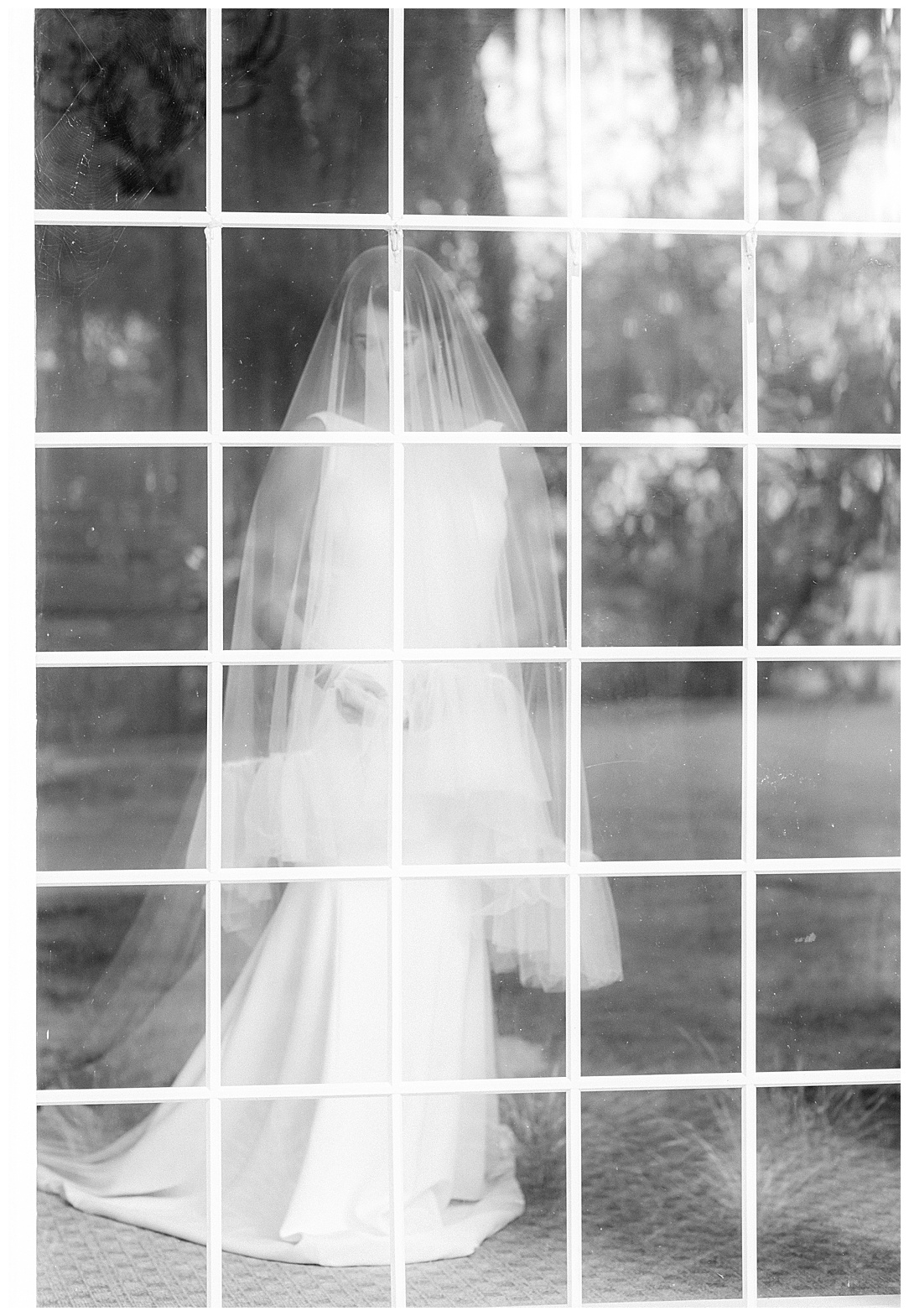 bride in front of full length window photographed from outside