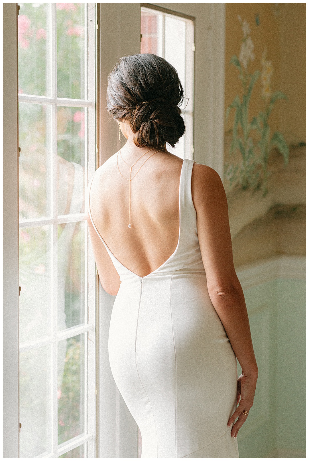 window portrait of bride from behind