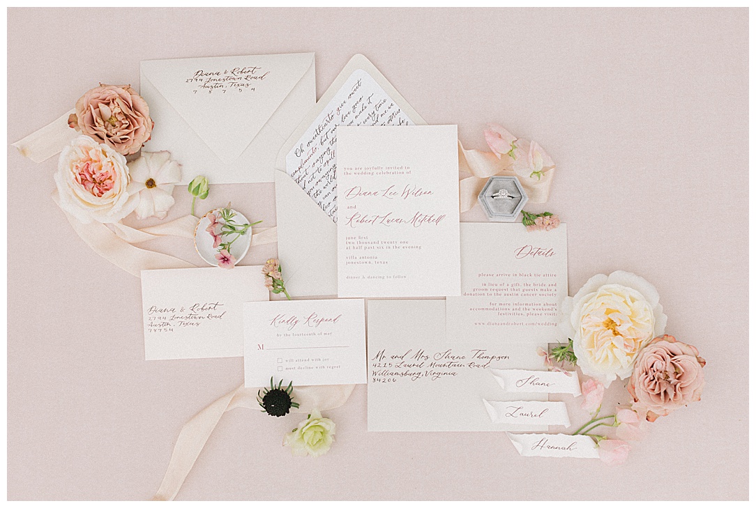 elegant floral and calligraphy flatlay invitation suite