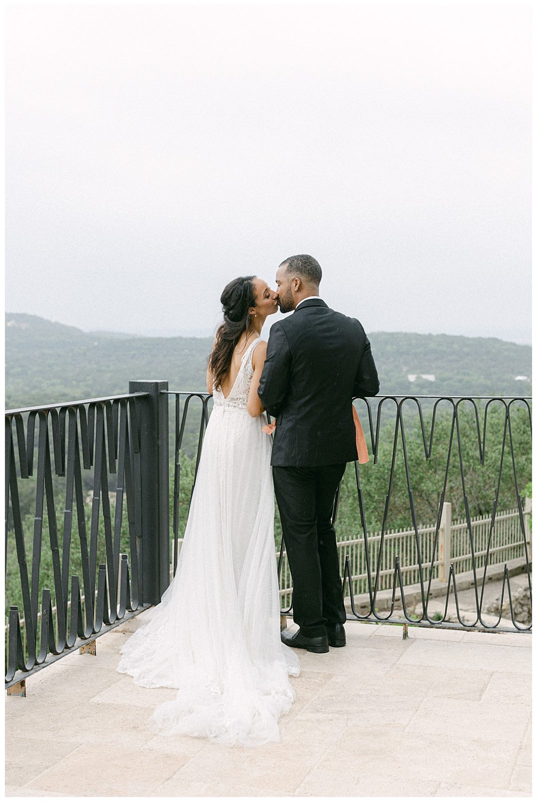 wedding couple kissing on the balcony at villa antonia wedding venue