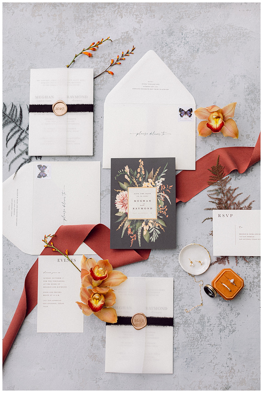 vertical invitation suite flatlay with ribbon and flowers