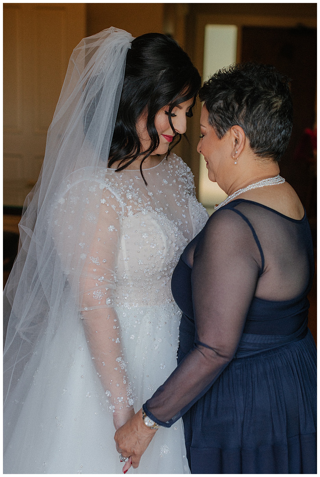 mother and bride having a private moment before wedding ceremony
