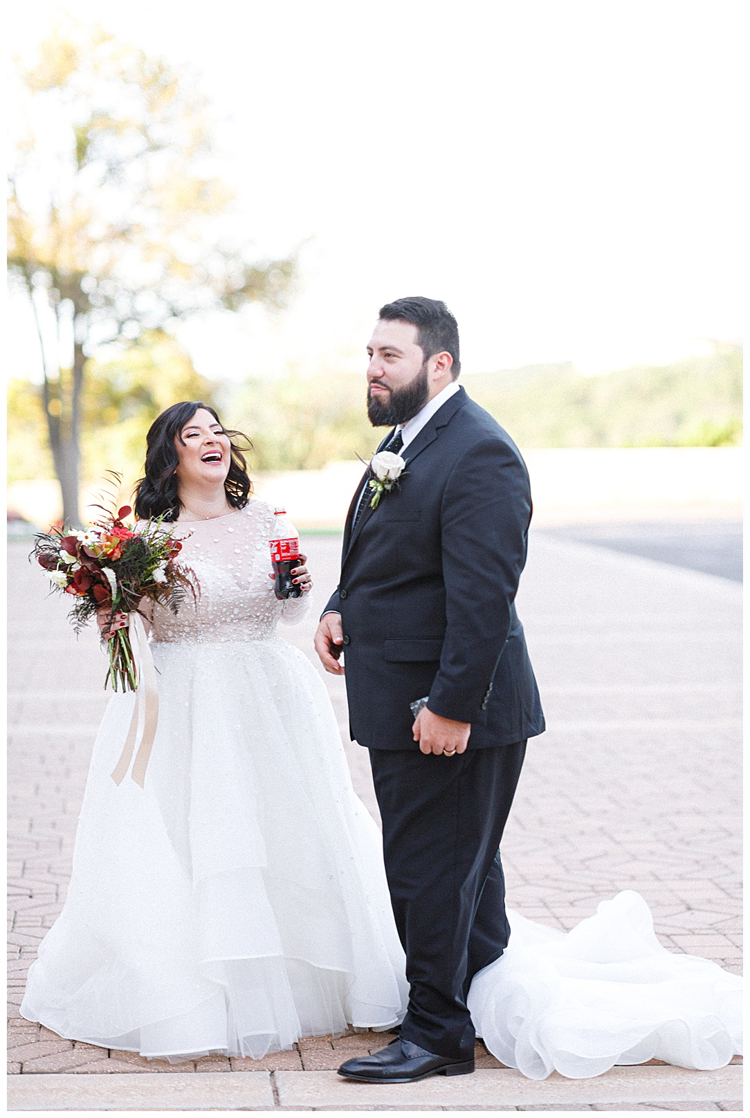 bride and groom sharing a laugh and a coke