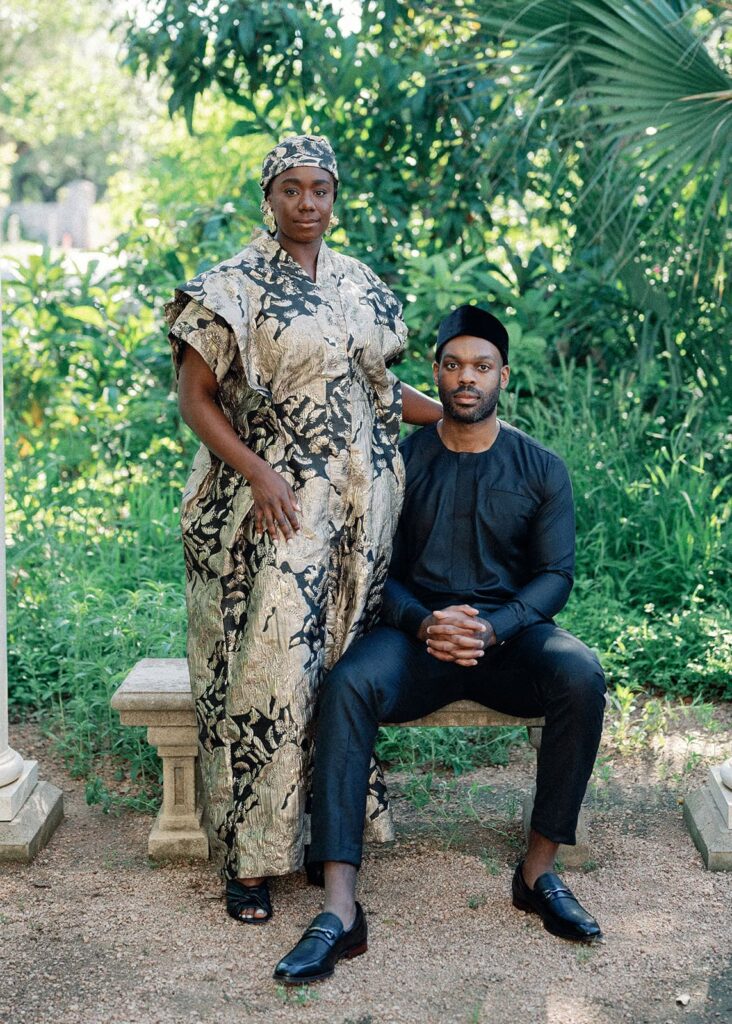 A woman stands next to her sitting fiance as they pose formally for their Austin engagement photos.