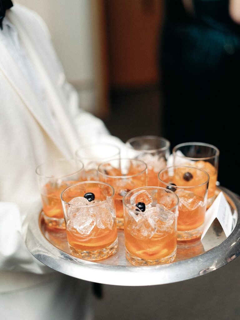 A tray of old fashions served by a caterer.