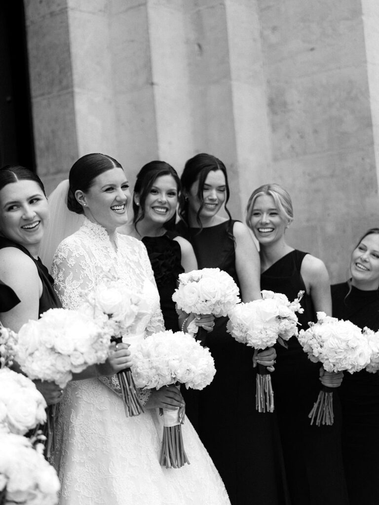 The bride poses with her bridesmaids in front of the San Fernando Cathedral.