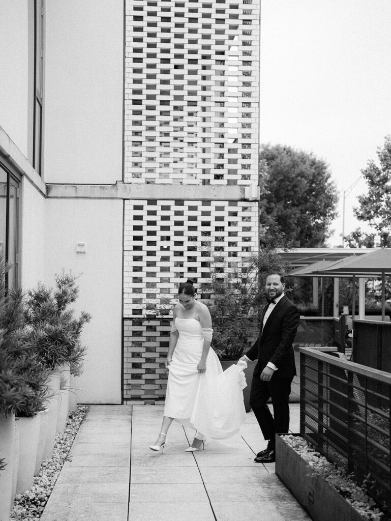 The wedding couple walking together outside of their South Congress Hotel wedding.