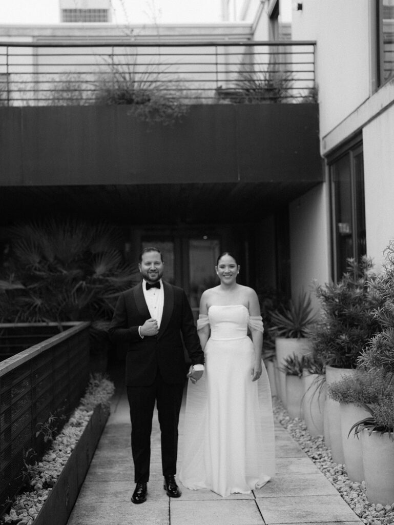 The wedding couple standing together outside of their South Congress Hotel wedding.