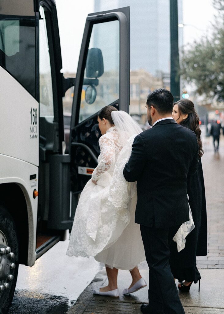 A bride walks into her bus transportation to show some of the time needed in your wedding photos timeline.